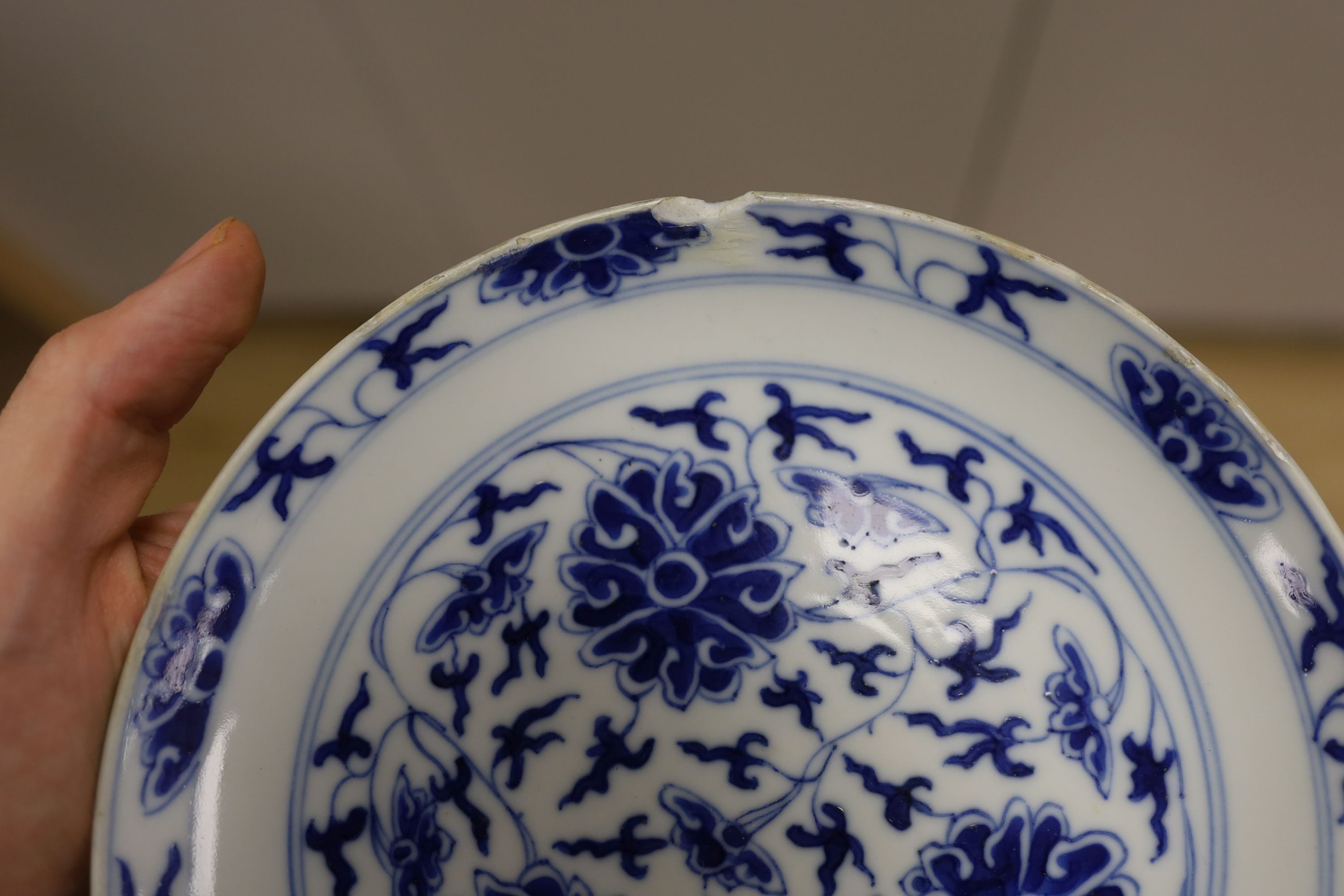A Chinese underglaze copper red ‘herder and goats’ vase, Kangxi six character mark but Republic period and a Chinese blue and white lotus stem dish, six character Guangxu mark and period, both damaged